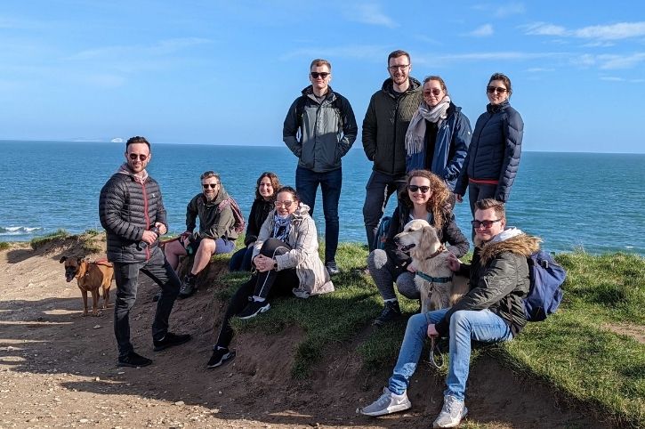 The team in front of the Dorset coastline