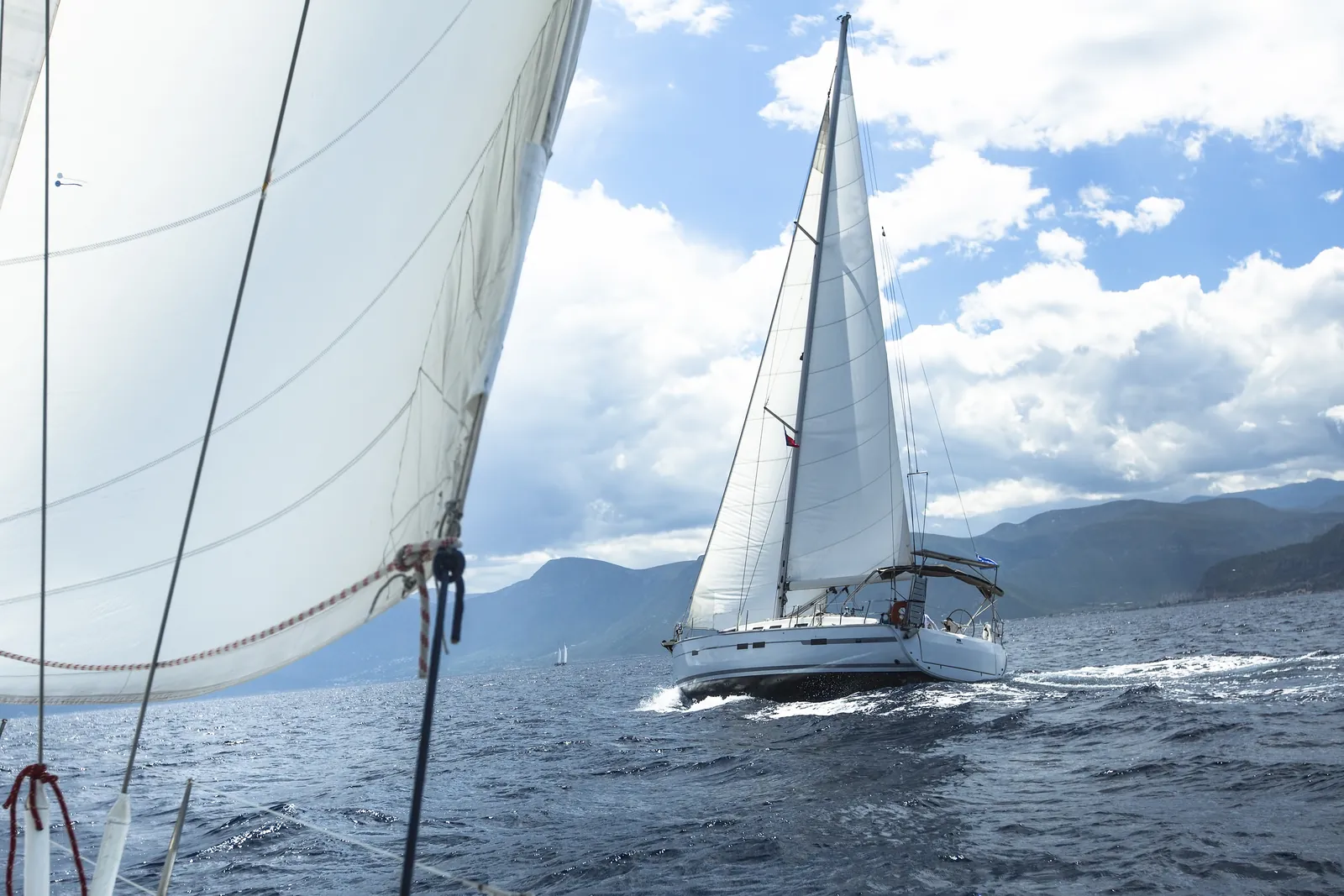 A yacht heeled over and driving hard upwind in a fresh breeze
