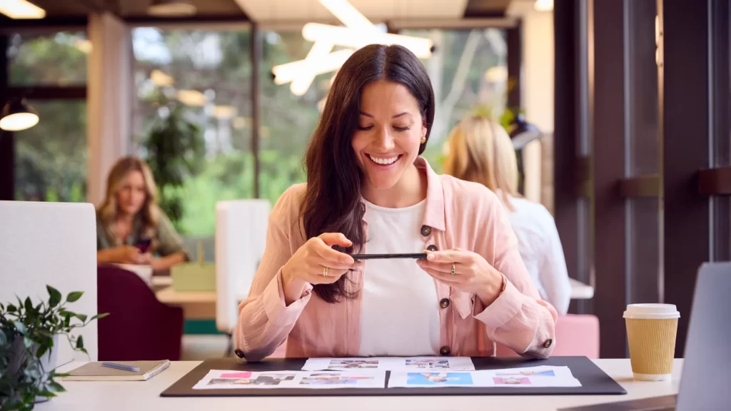 Woman Taking Photo of Design Layouts